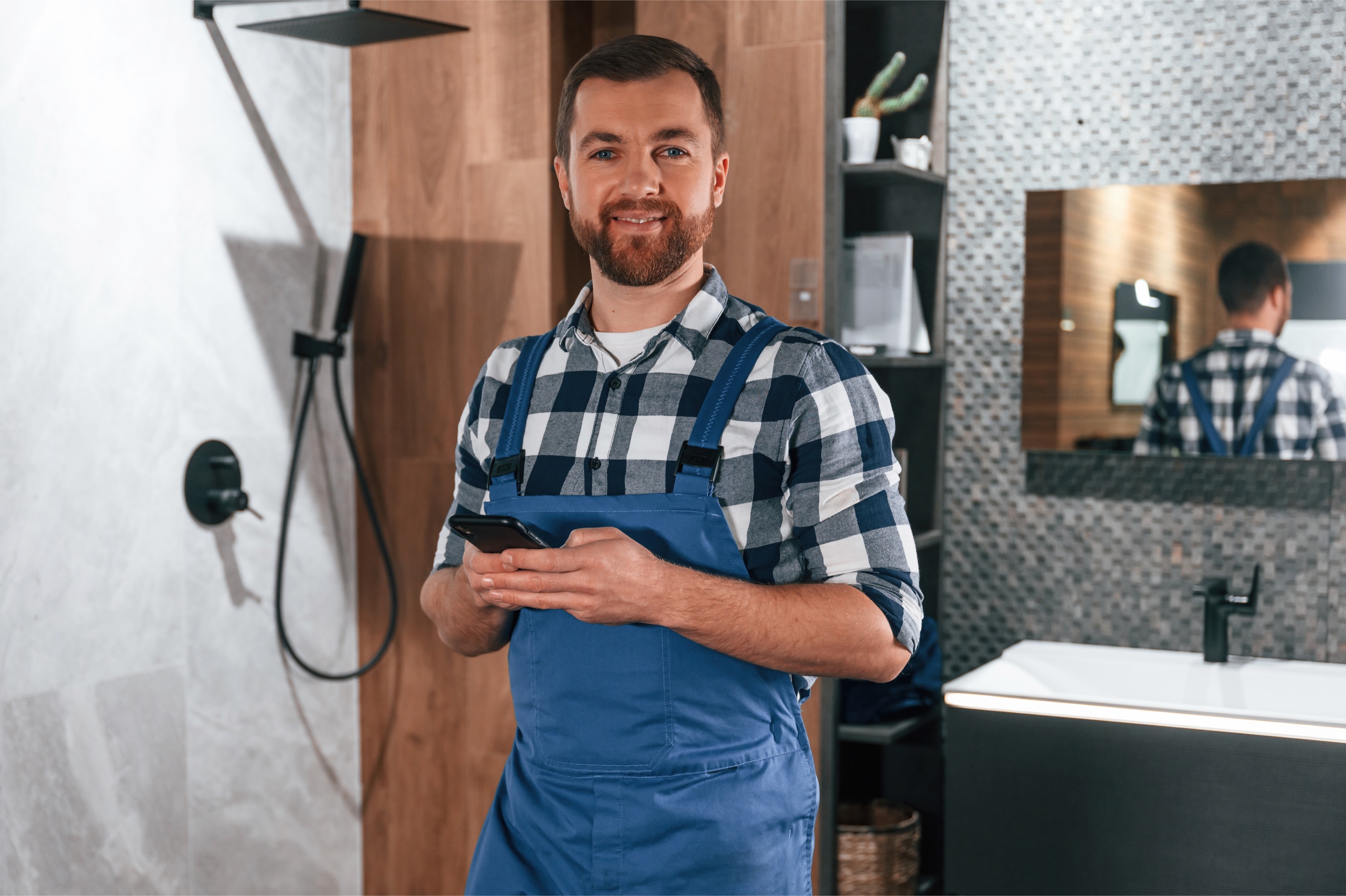 Professional plumber with tools ready for service